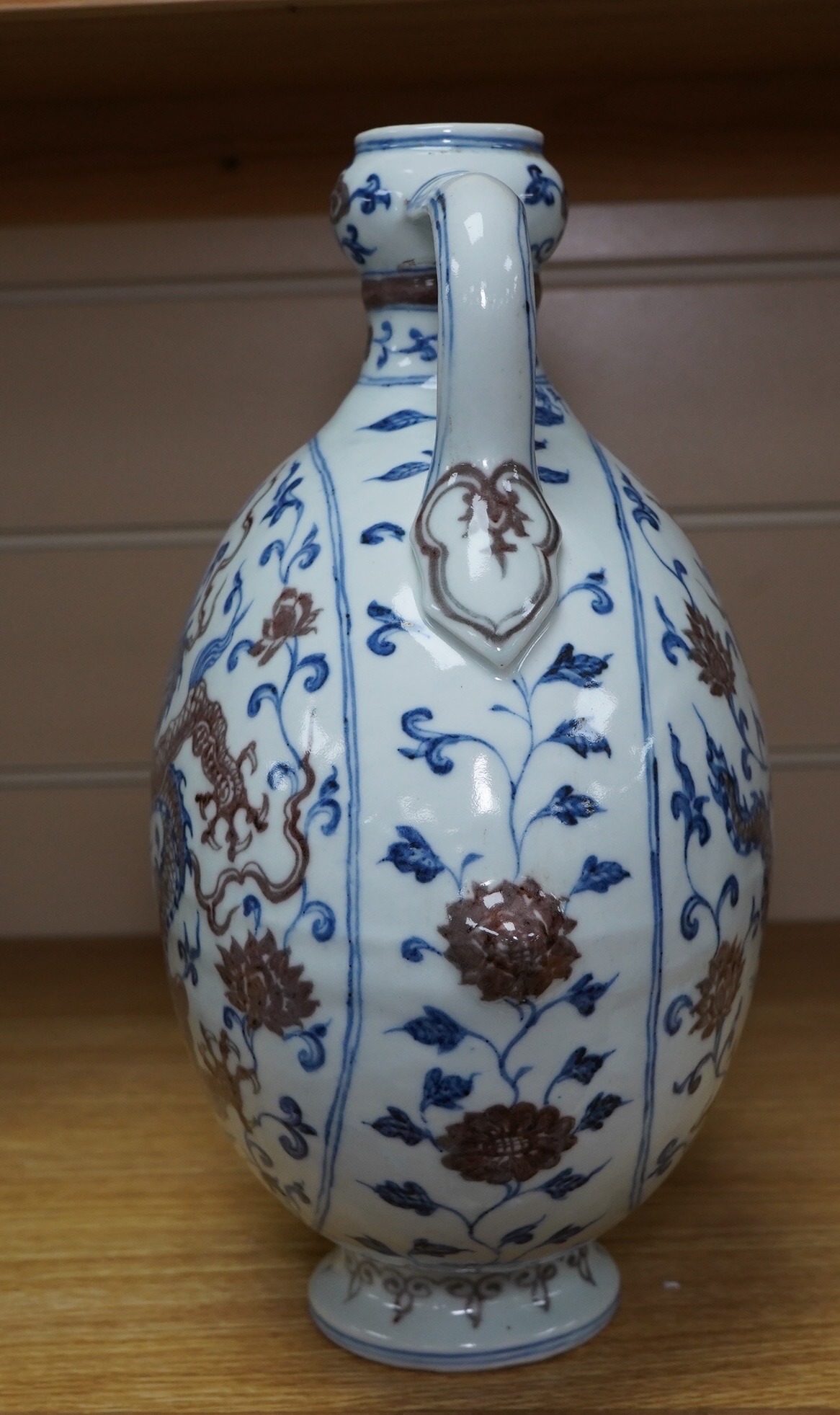 A Chinese blue and white with iron red two handled moon flask, 29cm high. Condition - good